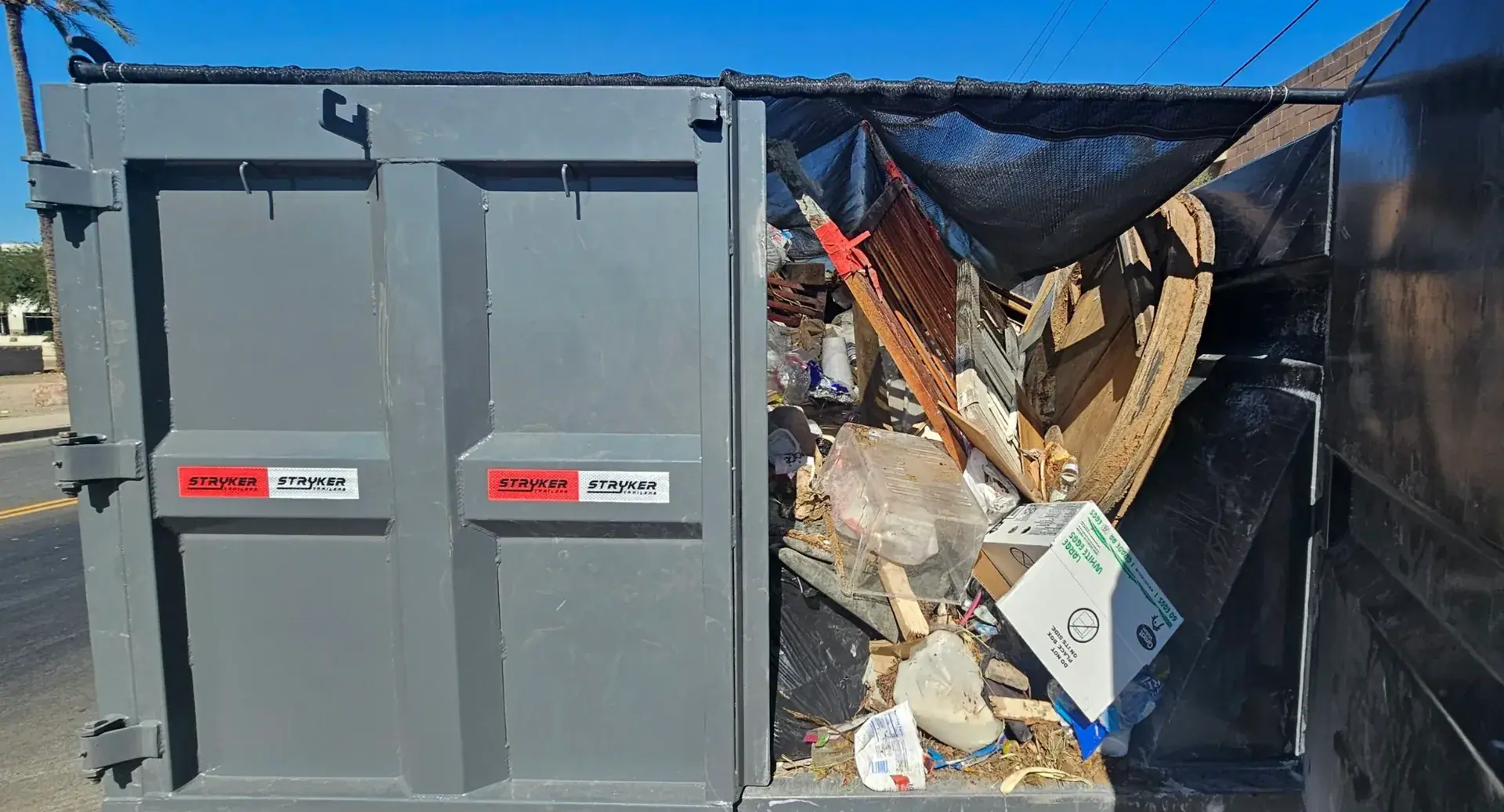 Renovation debris loaded inside a Waste Wizards dumpster
