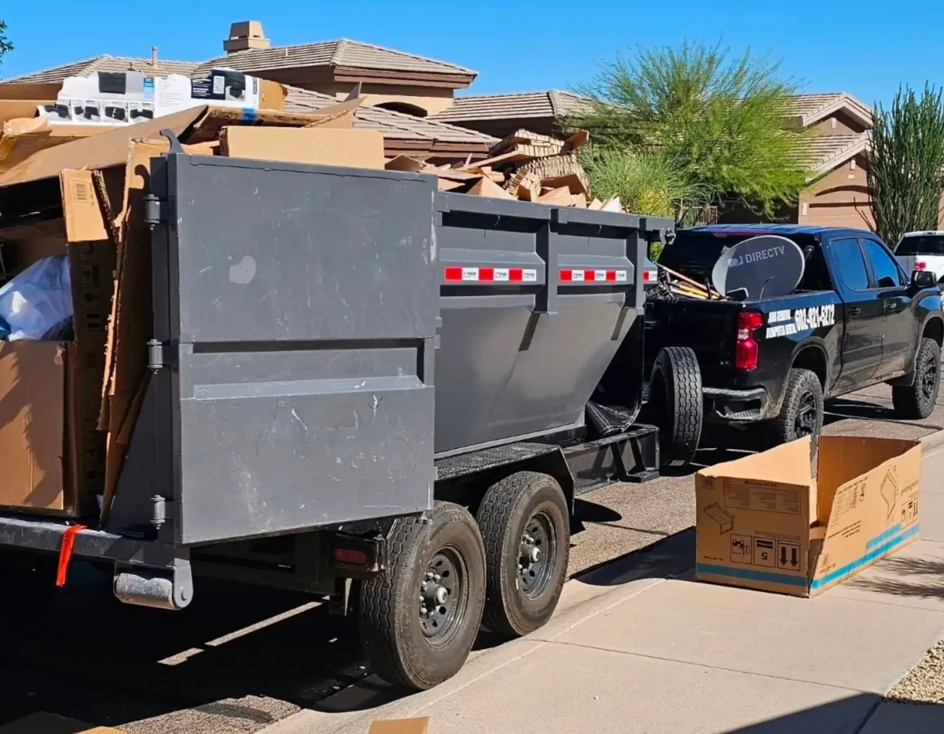 Waste Wizards truck and dumpster loaded with furniture and household items