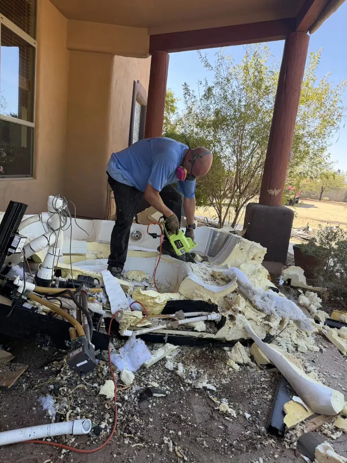 Waste Wizards crew dismantling an old hot tub on a Scottsdale patio