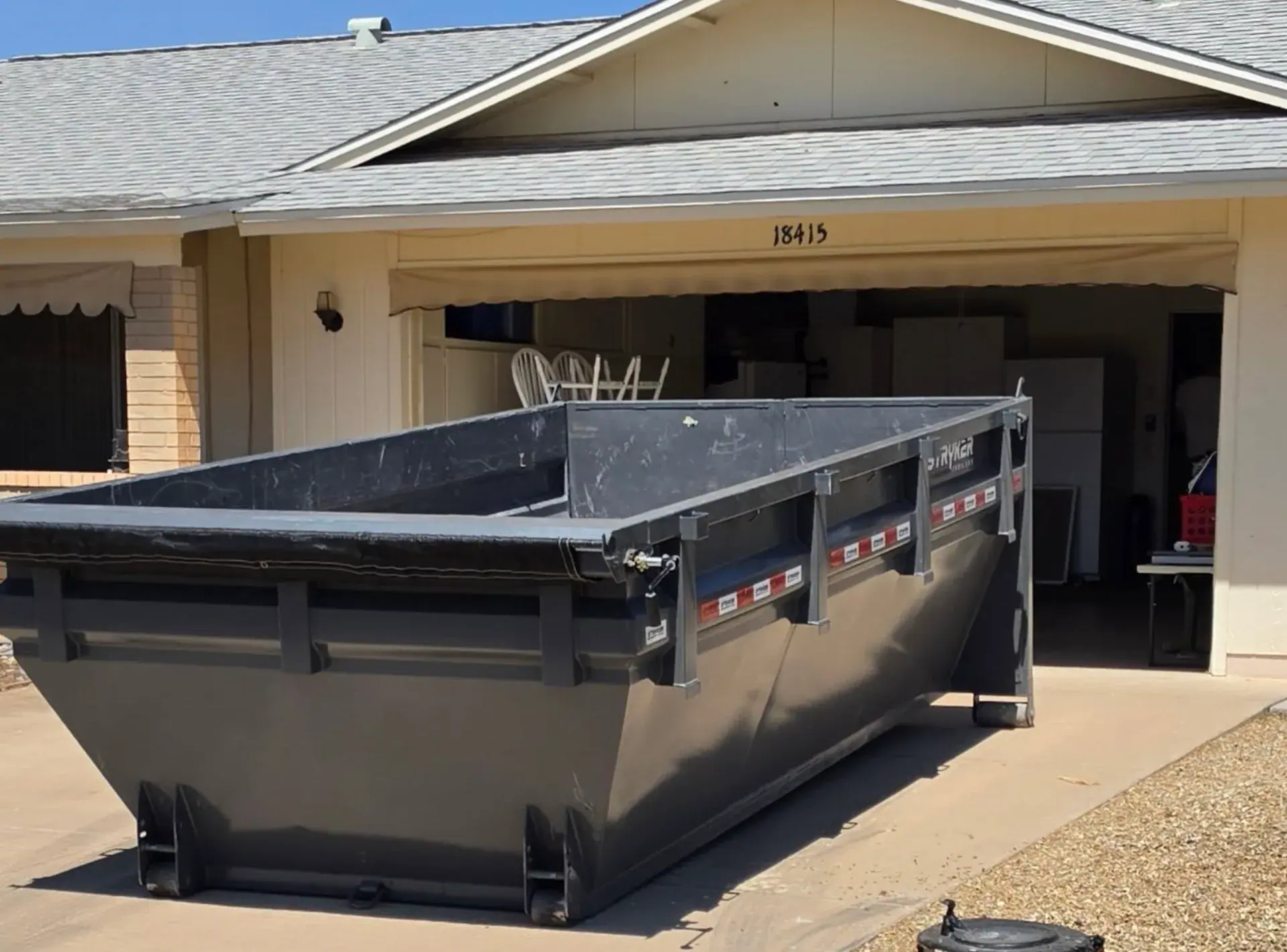 Waste Wizards roll-off dumpster delivered to a residential driveway