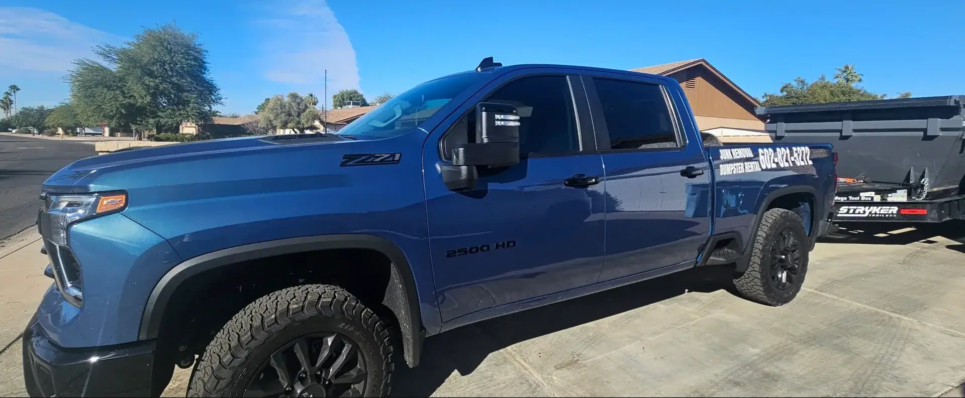 Blue Waste Wizards truck and dumpster ready for a Scottsdale junk removal job